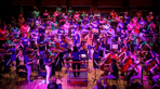 National Orchestra for All performs at CBSO Centre in Birmingham as a NOFA member conducts the ensemble.png