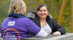 Volunteer-talking-to-a-mum-outside-on-bench-400x250.jpg
