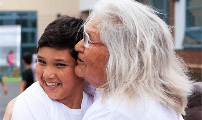 older_woman_hugs_young_boy_qs_2021_10_13_10_24_57_am