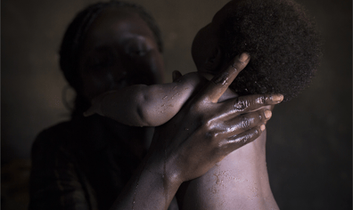 28_wg_facilitator_jackline_ajok_washing_her_baby_boy_at_home_uganda_2018_03_09_03_49_31_pm