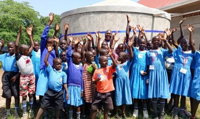 Children-celebrate-getting-water-tanks_St-Ann-Kiziba-Primary-School-1024x461 (1)