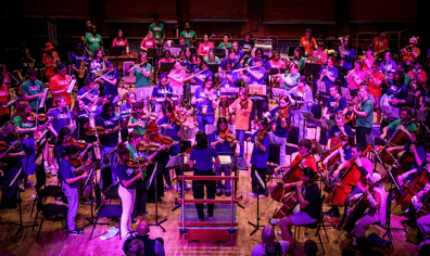 National Orchestra for All performs at CBSO Centre in Birmingham as a NOFA member conducts the ensemble