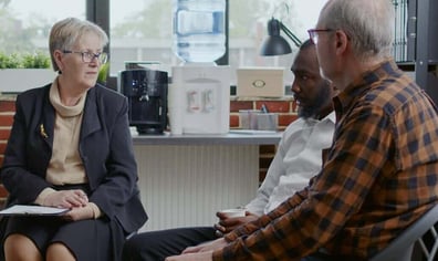 woman-psychiatrist-giving-advice-to-multi-ethnic-people-with-addiction-at-aa-therapy-session-e1660303014208