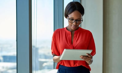 woman-using-tablet-device-in-skyscrapper-building