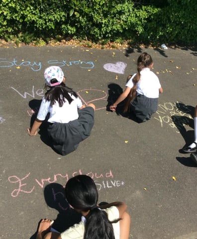 Girls chalking playground